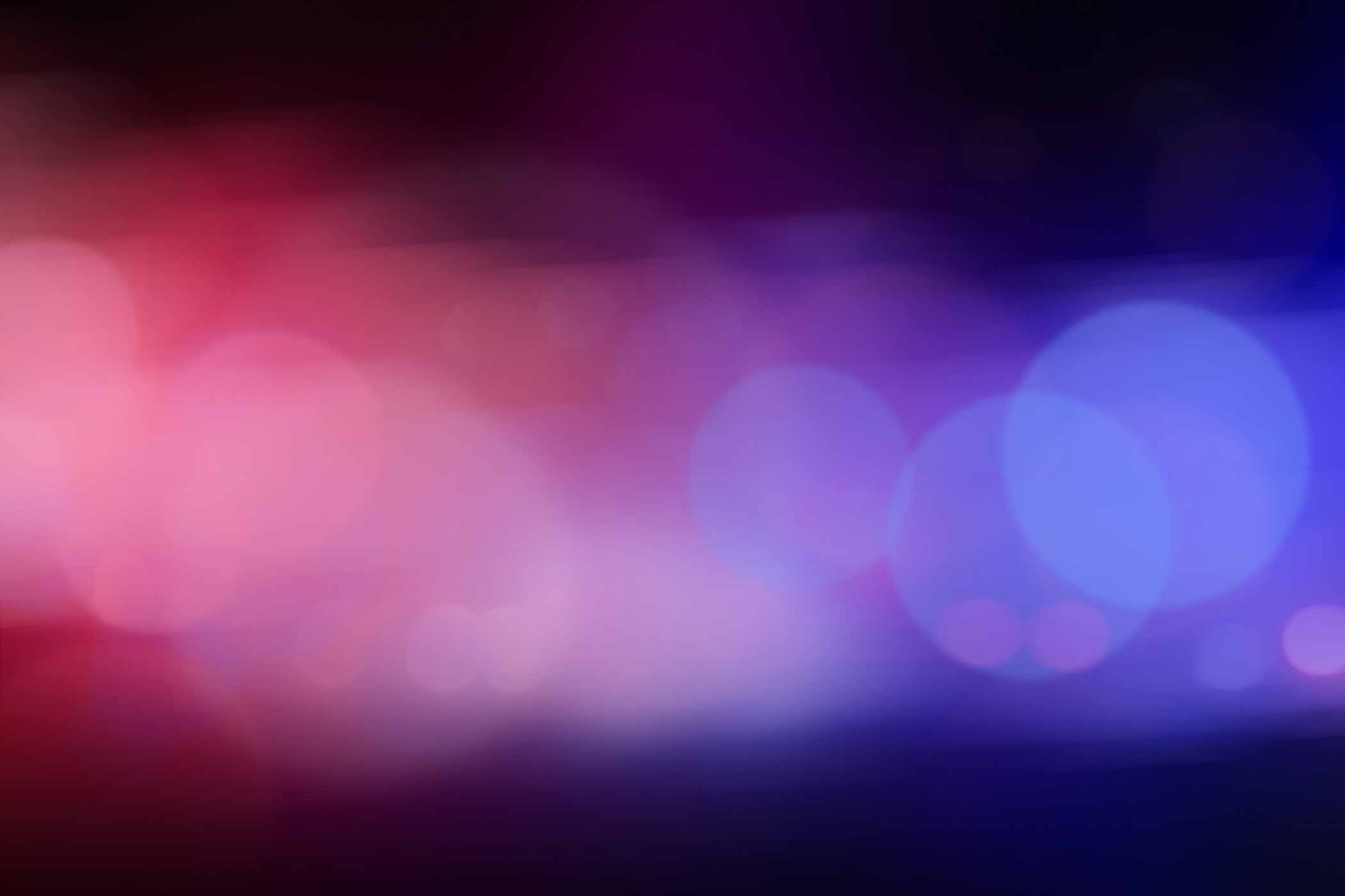 Blurred view of police cars on street at night